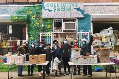 Volunteers standing in front of the Collective Focus building